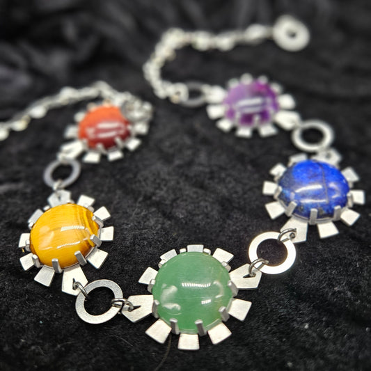 Choker necklace with colorful stone charms on a black textured background